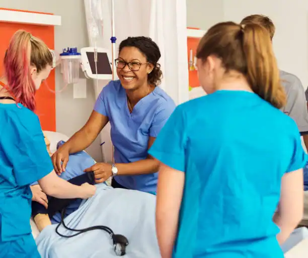 Vocational nursing students practicing hands-on patient care during clinical training.